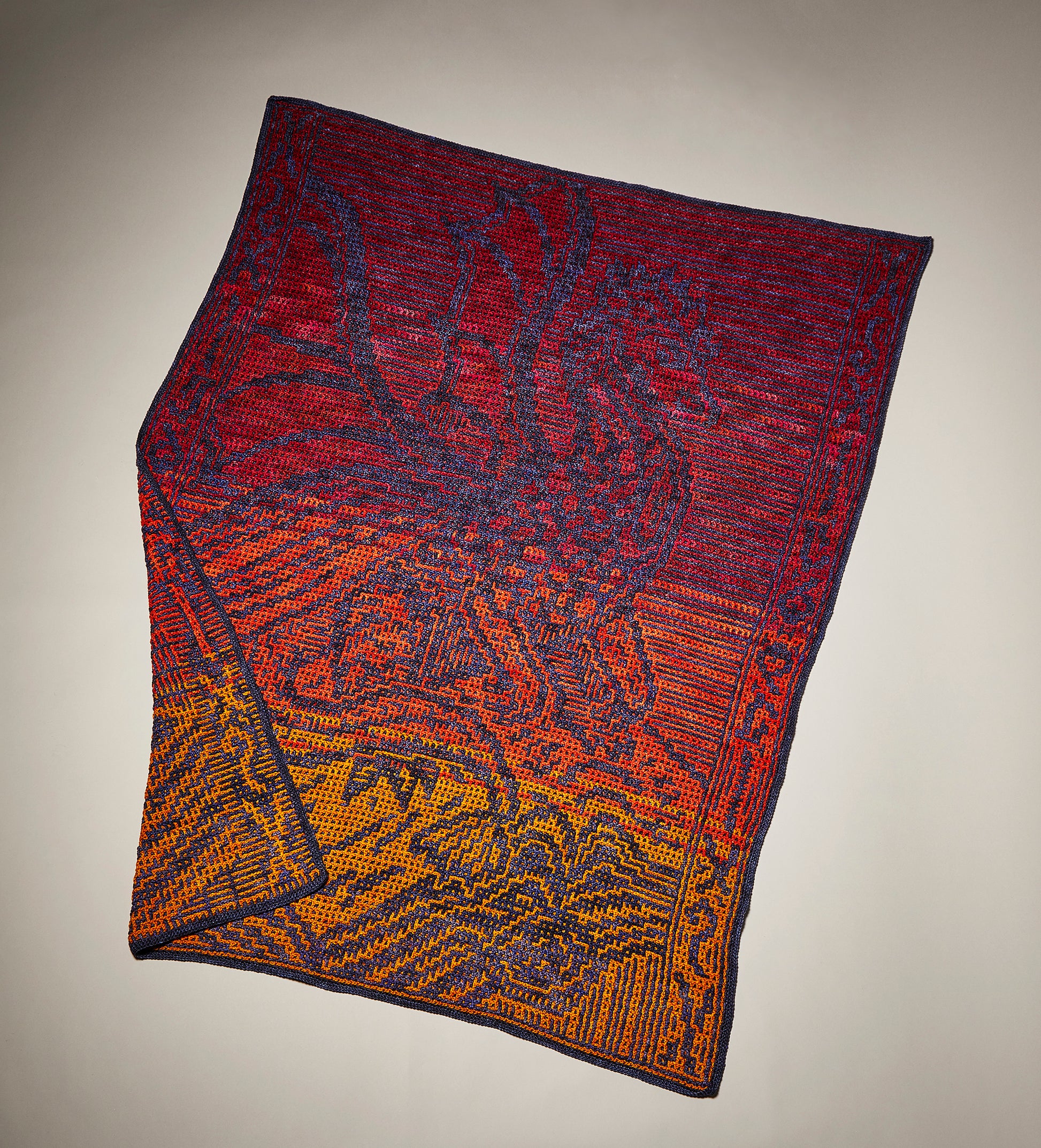 Crochet blanket of a dragon and books