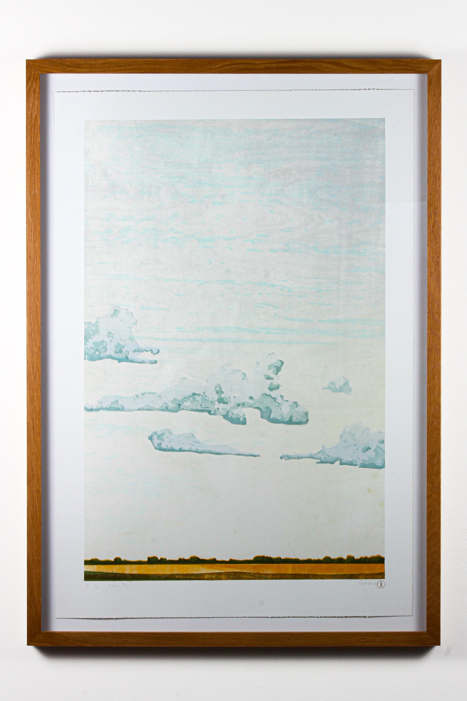 Framed artwork of a landscape and clouds