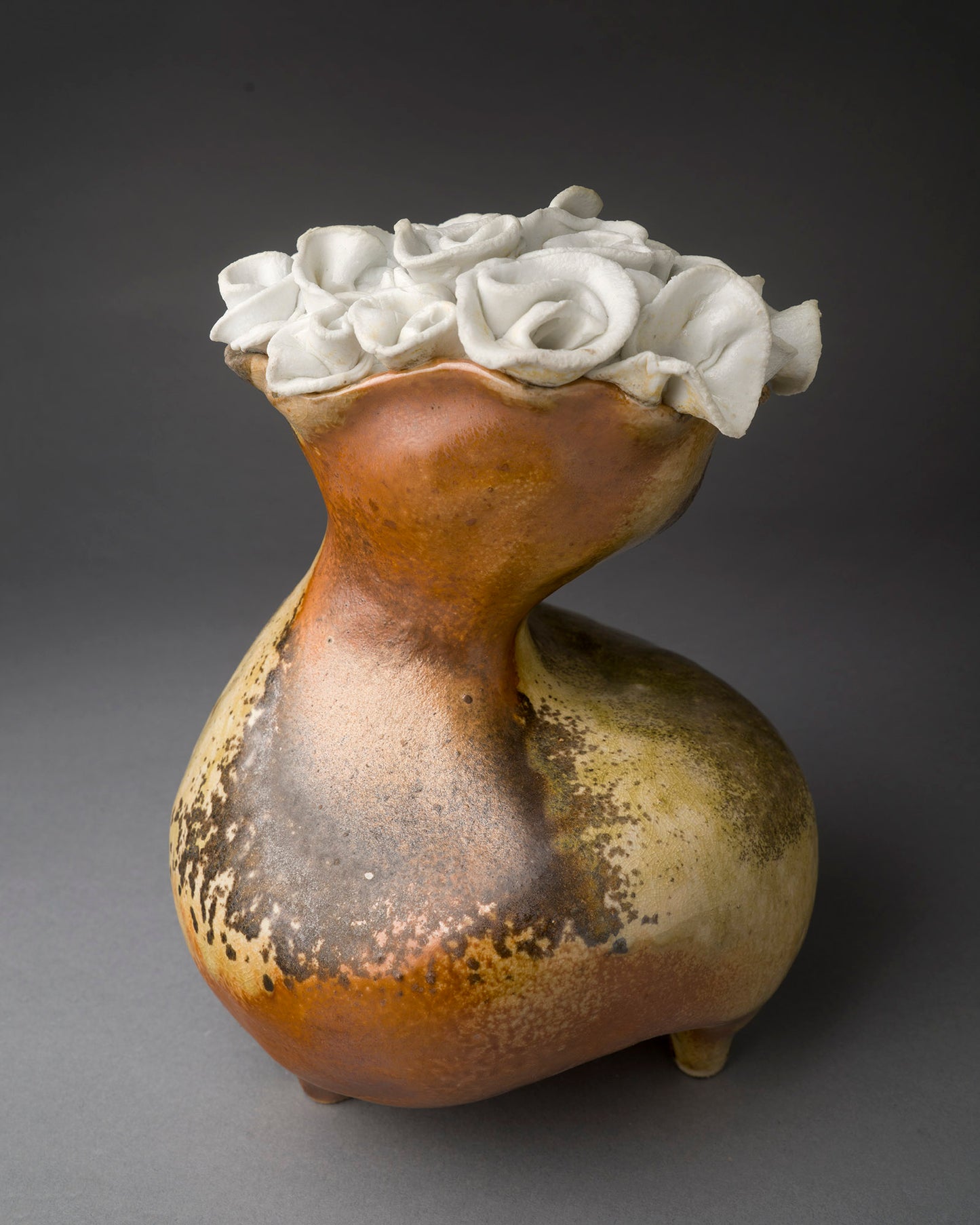 Abstract vase with clay white roses