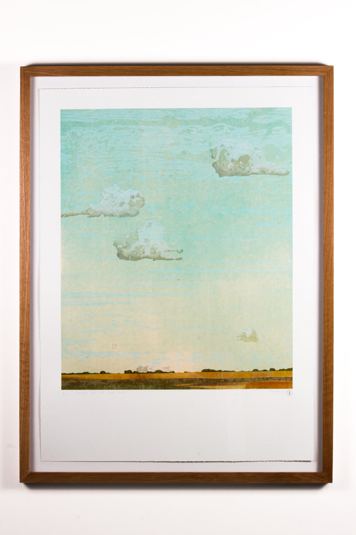 Framed wood cut print of clouds in a blue and yellow sky over a golden yellow field in Saskatchewan.