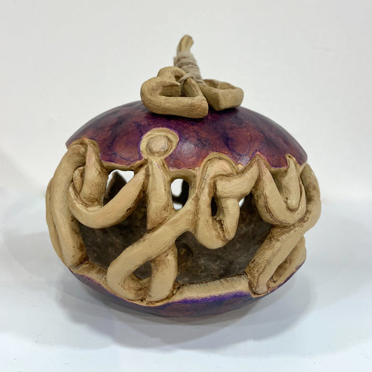 Purple gourd with joy carved through the centre and two heart pieces