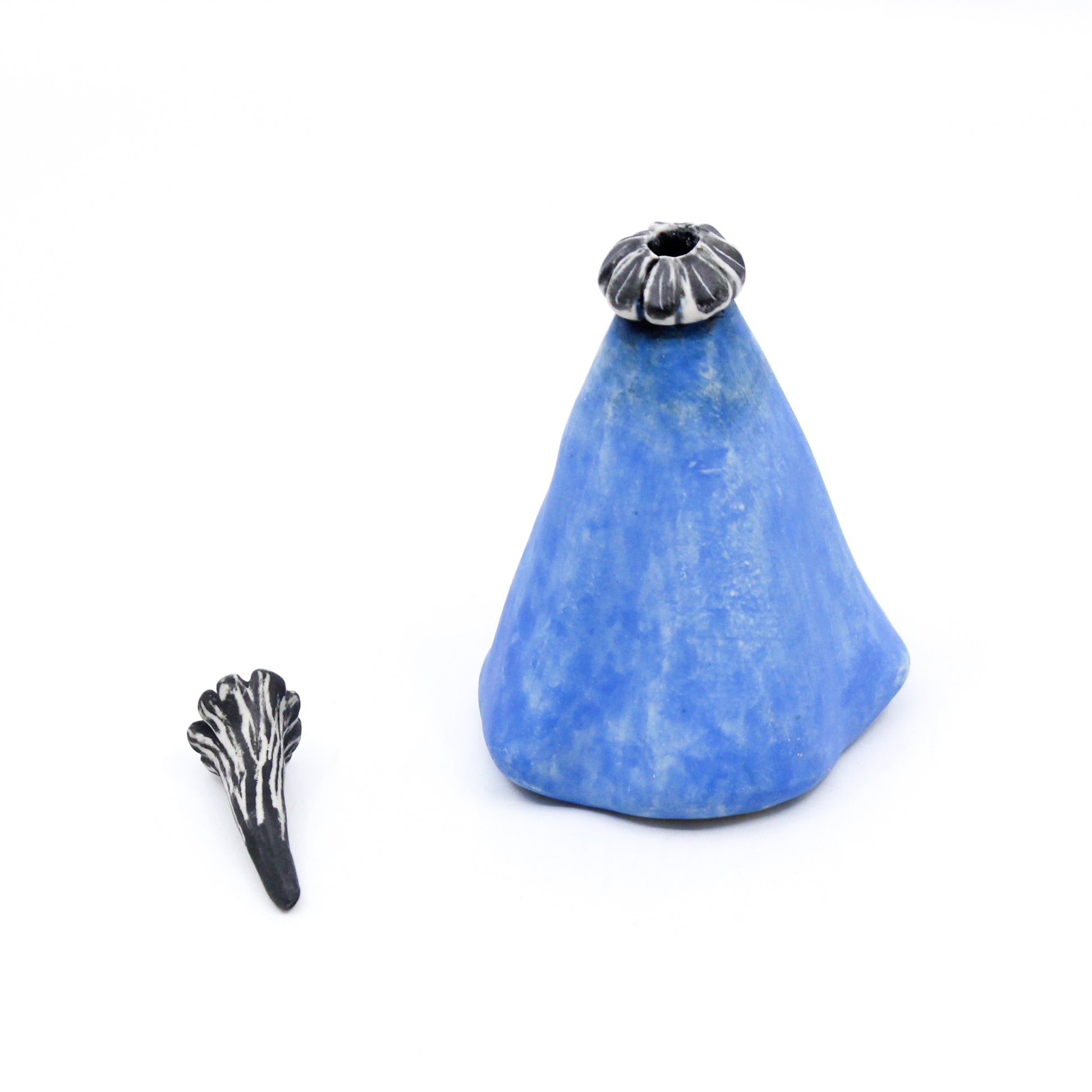 Blue pod bottle with black and white stopper