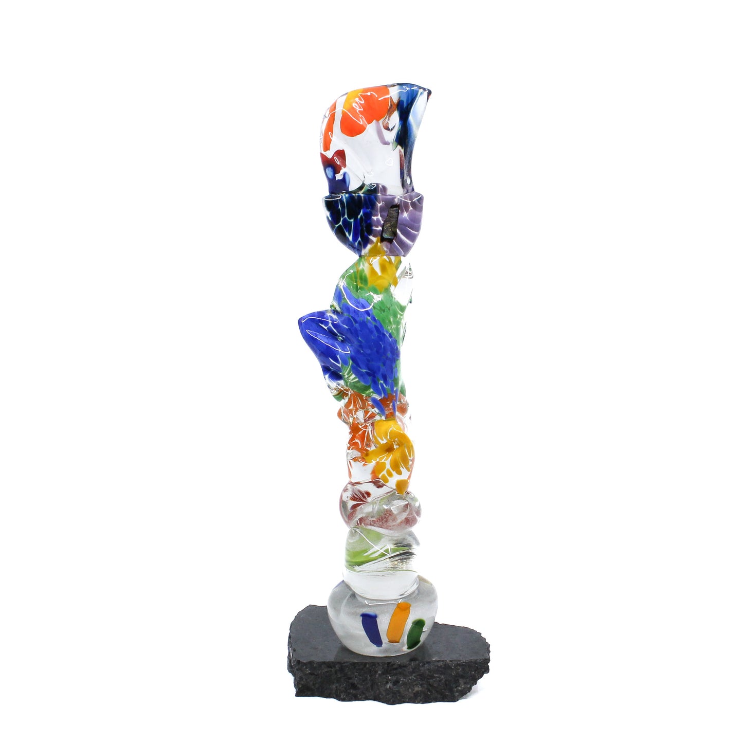 Multicoloured glass stick mounted on a rock
