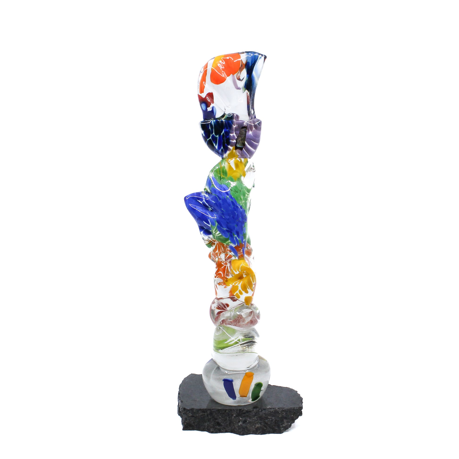 Multicoloured glass stick mounted on a rock