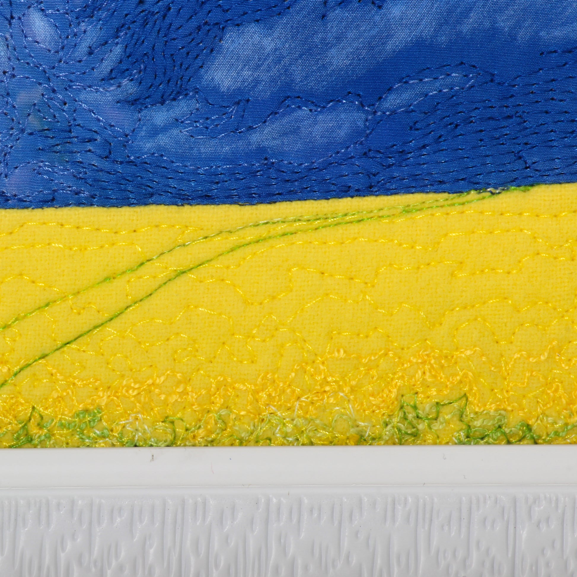 prairie thread painting of canola field and trail