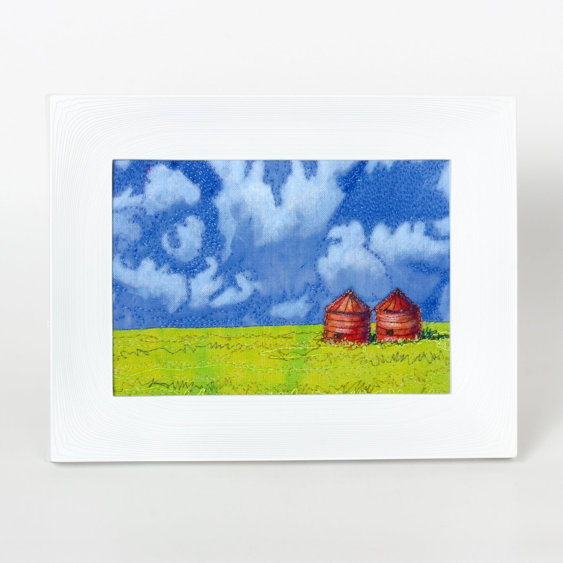 prairie thread painting of field and granaries