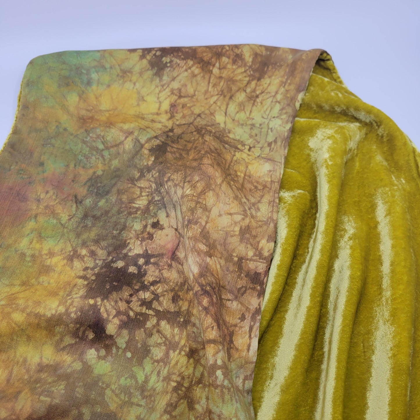 Lime green/yellow velvet scarf on a white background