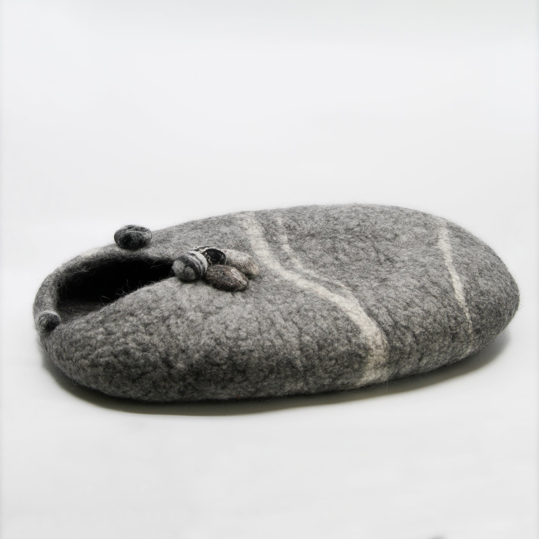 Grey cat house with rocks