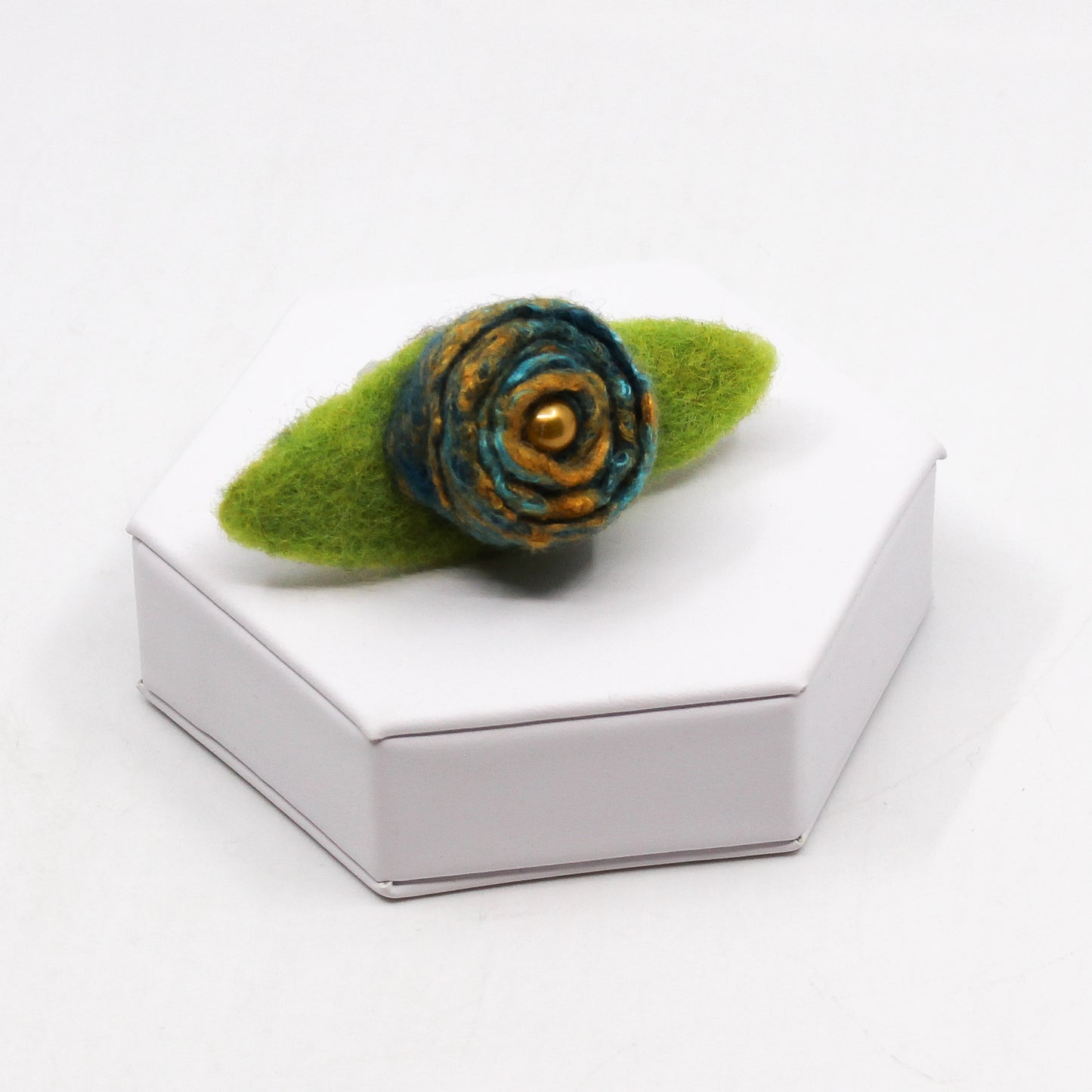 Teal and yellow flower with green leaves