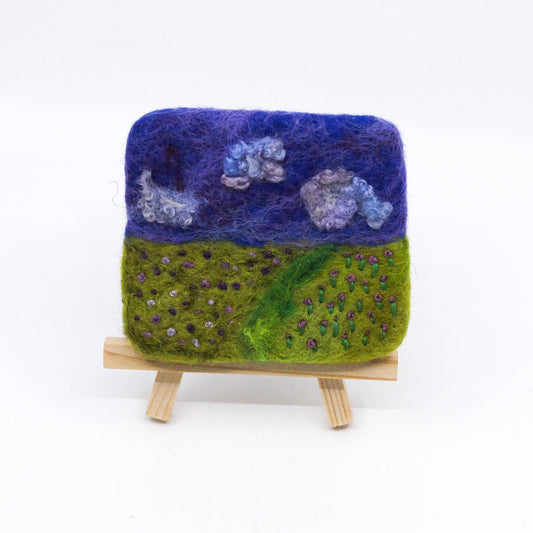 Felted landscape of purple flowers on wooden easel