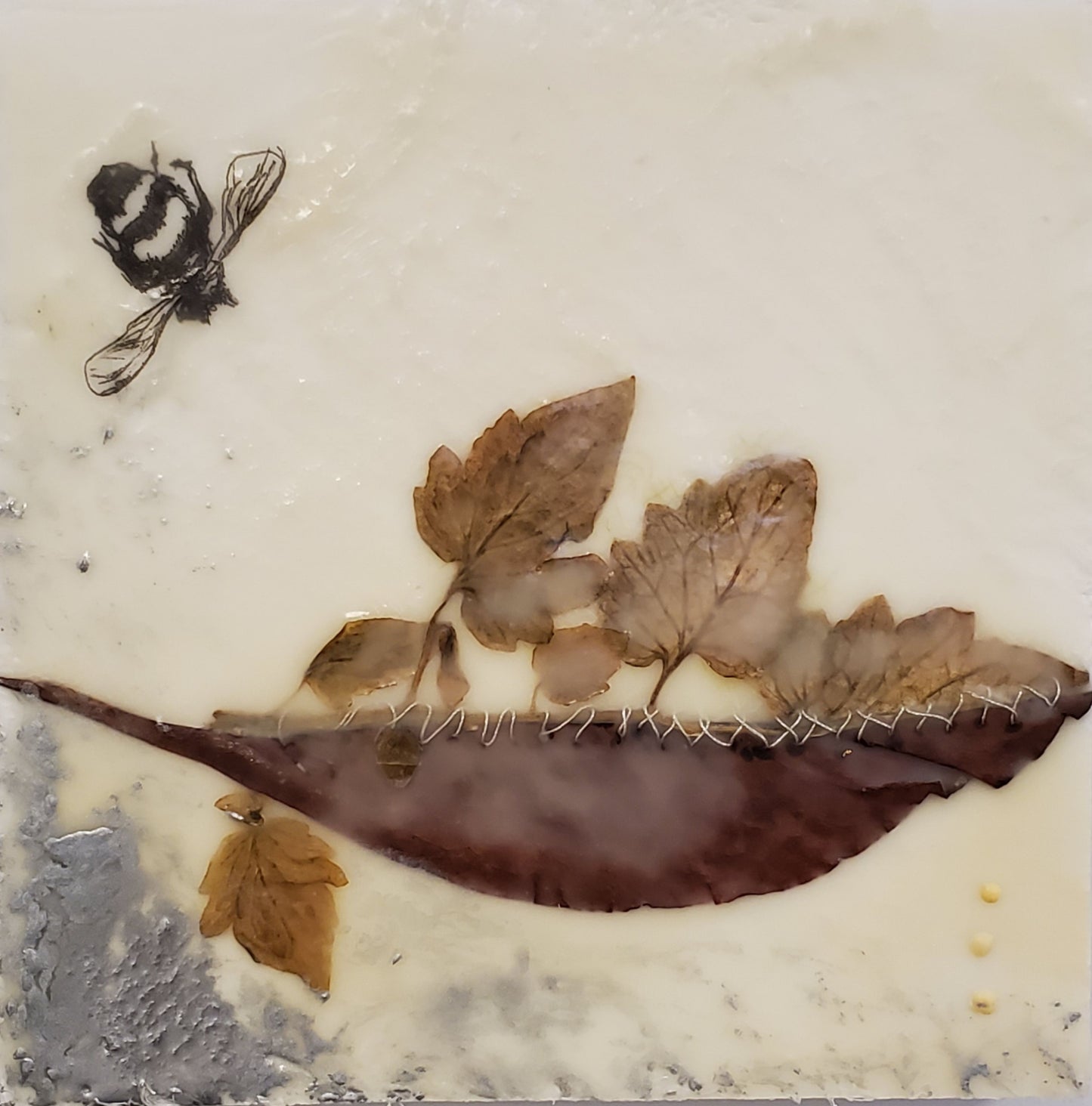 Wax encaustic panel of a bee with leaves