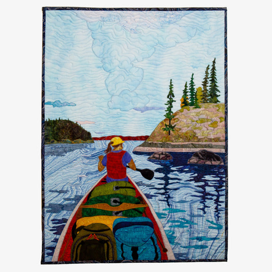 Quilted tapestry of a canoe on the lake
