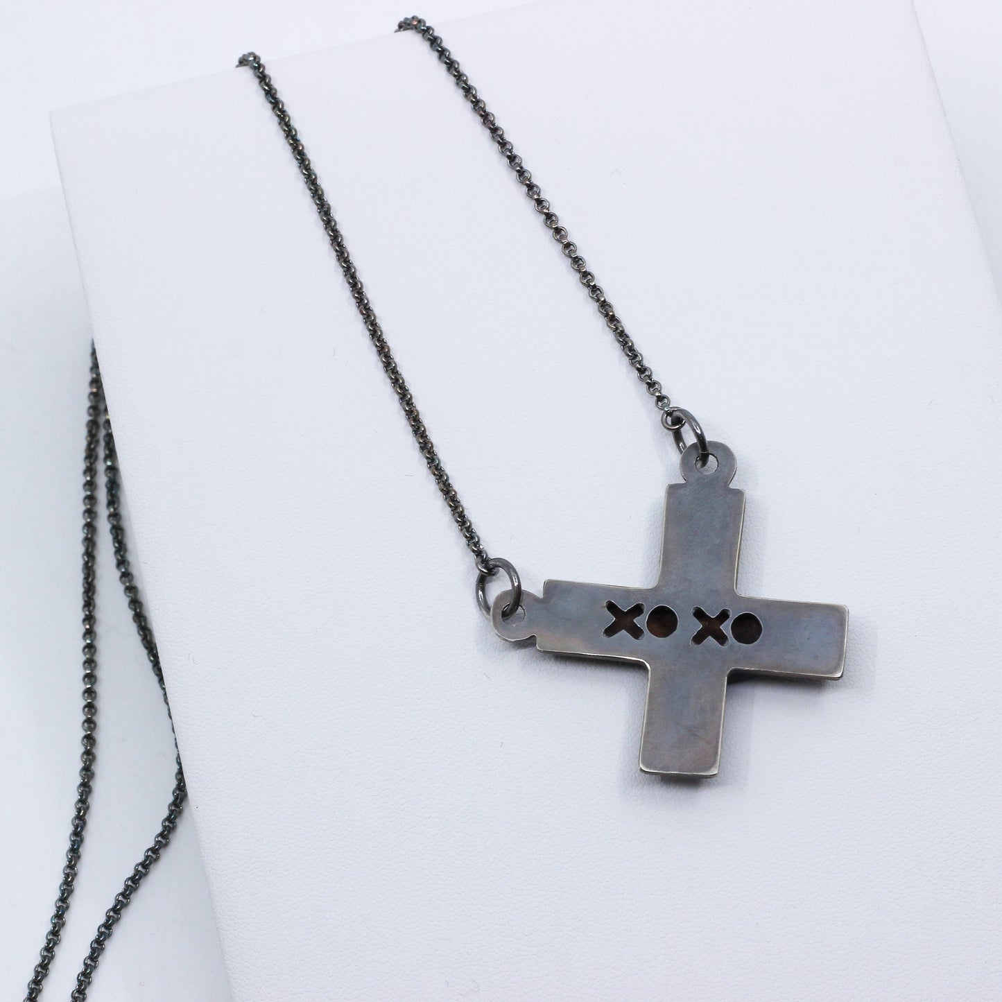 Back of X-shaped pendant