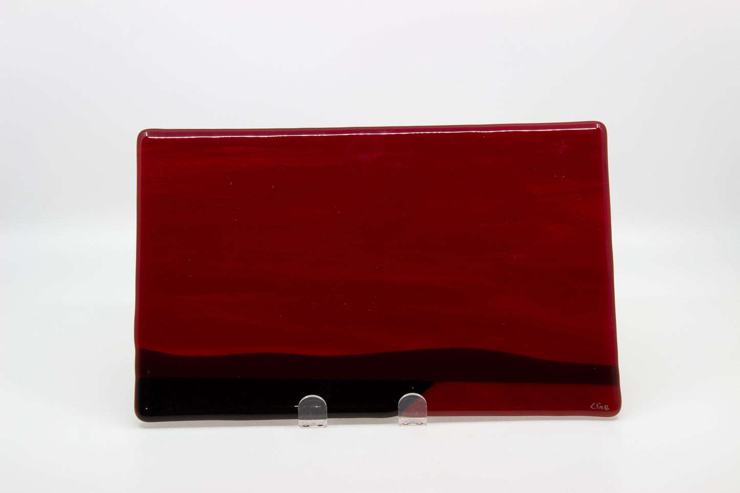 Glass tablet of a red sky with dark ground