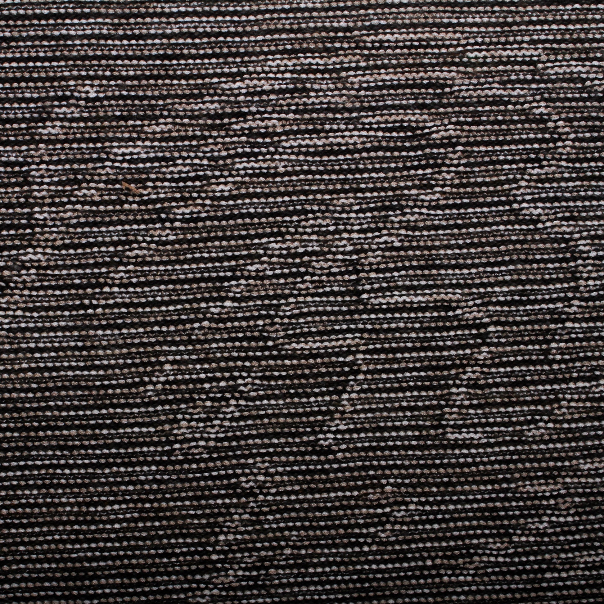 Knitted wall hanging in cream and dark brown yarn and metallic thread.