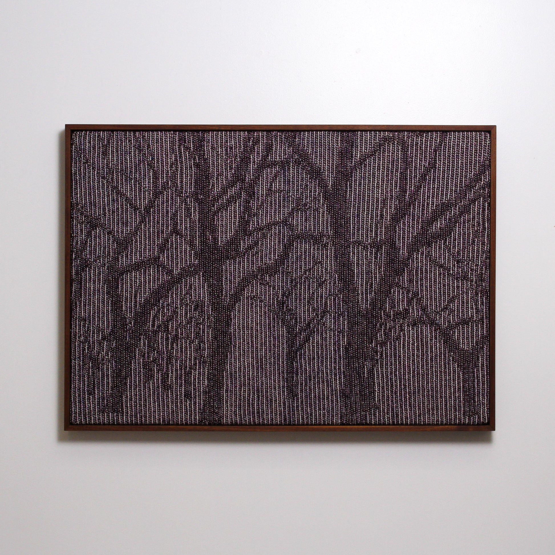 Framed knitted landscape of trees in dark brown, cream and maroon yarn with metallic thread