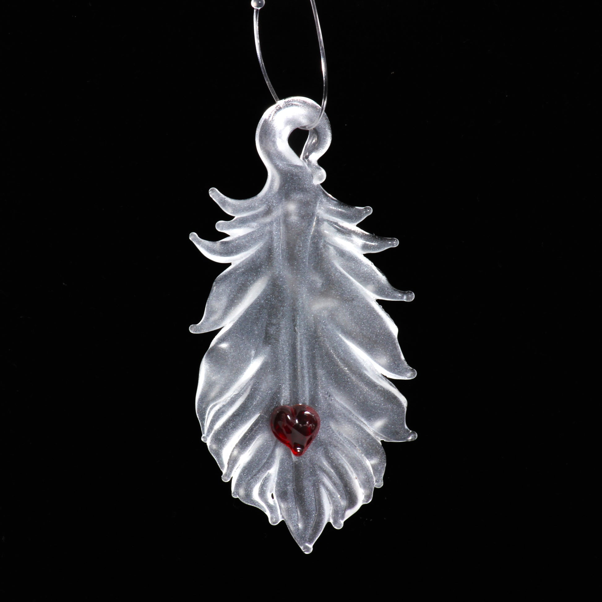translucent feather with red heart ornament