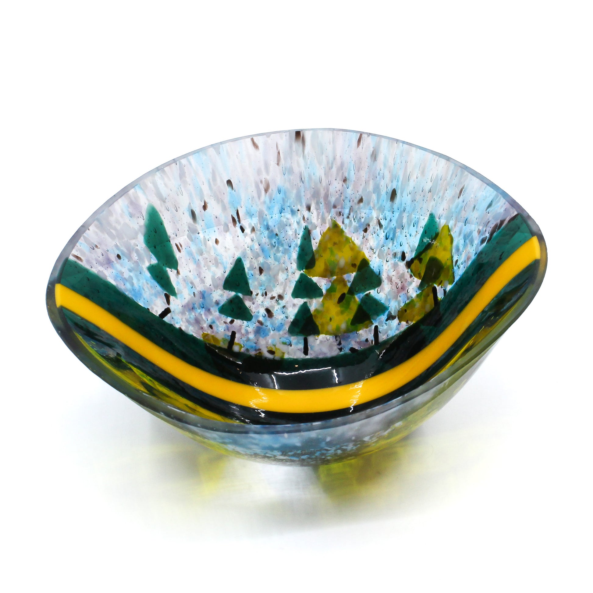 Glass vessel with green fir trees