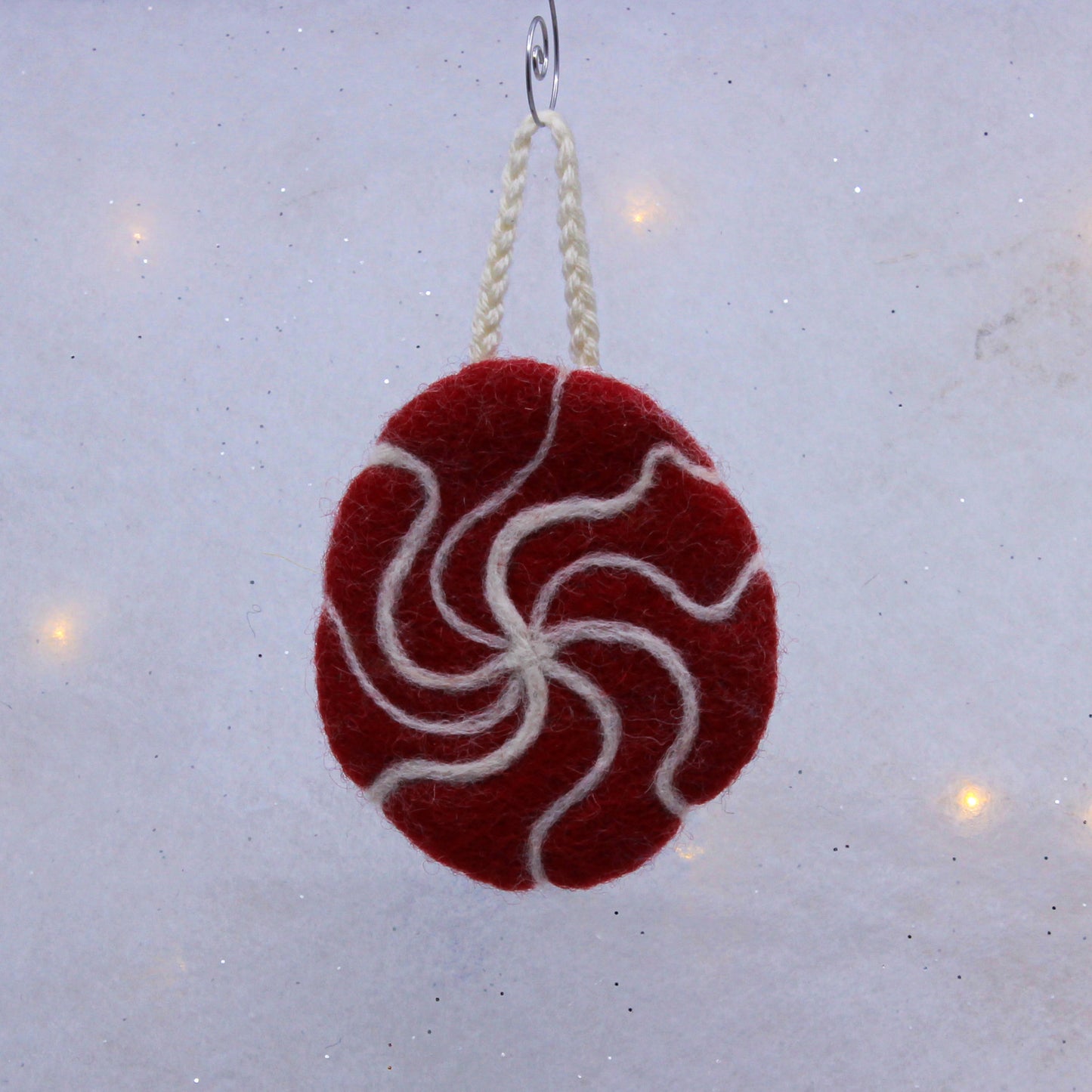 Snowflake on red circle, felted ornament