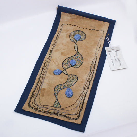 Embroidered wall hanging of blue abstract on natural dyed cloth