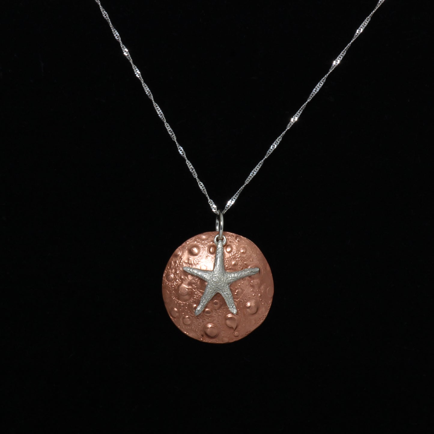 Copper sand dollar and silver starfish necklace
