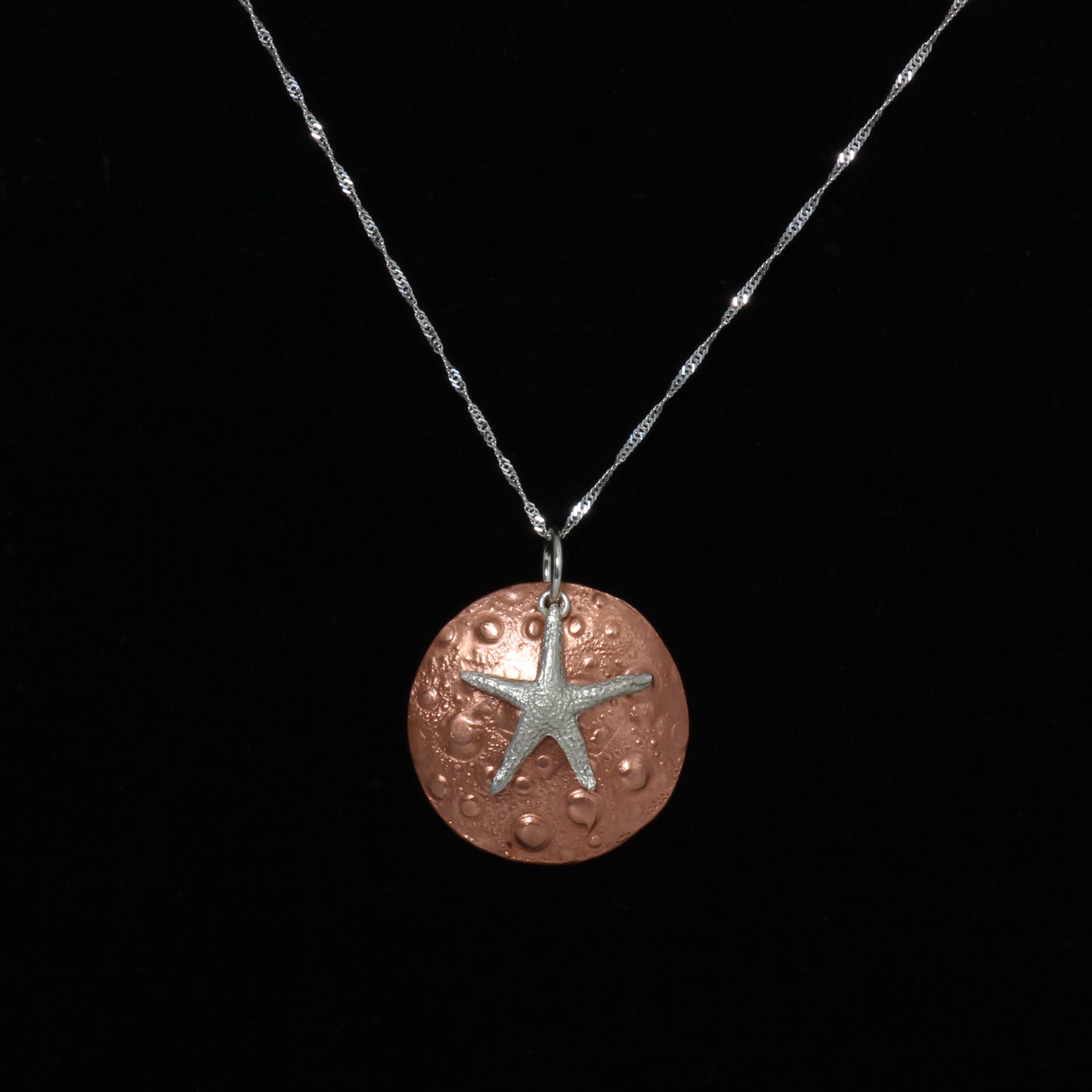 Copper sand dollar and silver starfish necklace