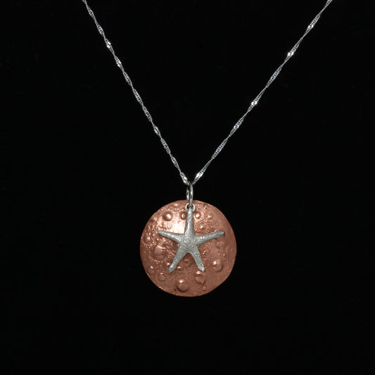 Copper sand dollar and silver starfish necklace