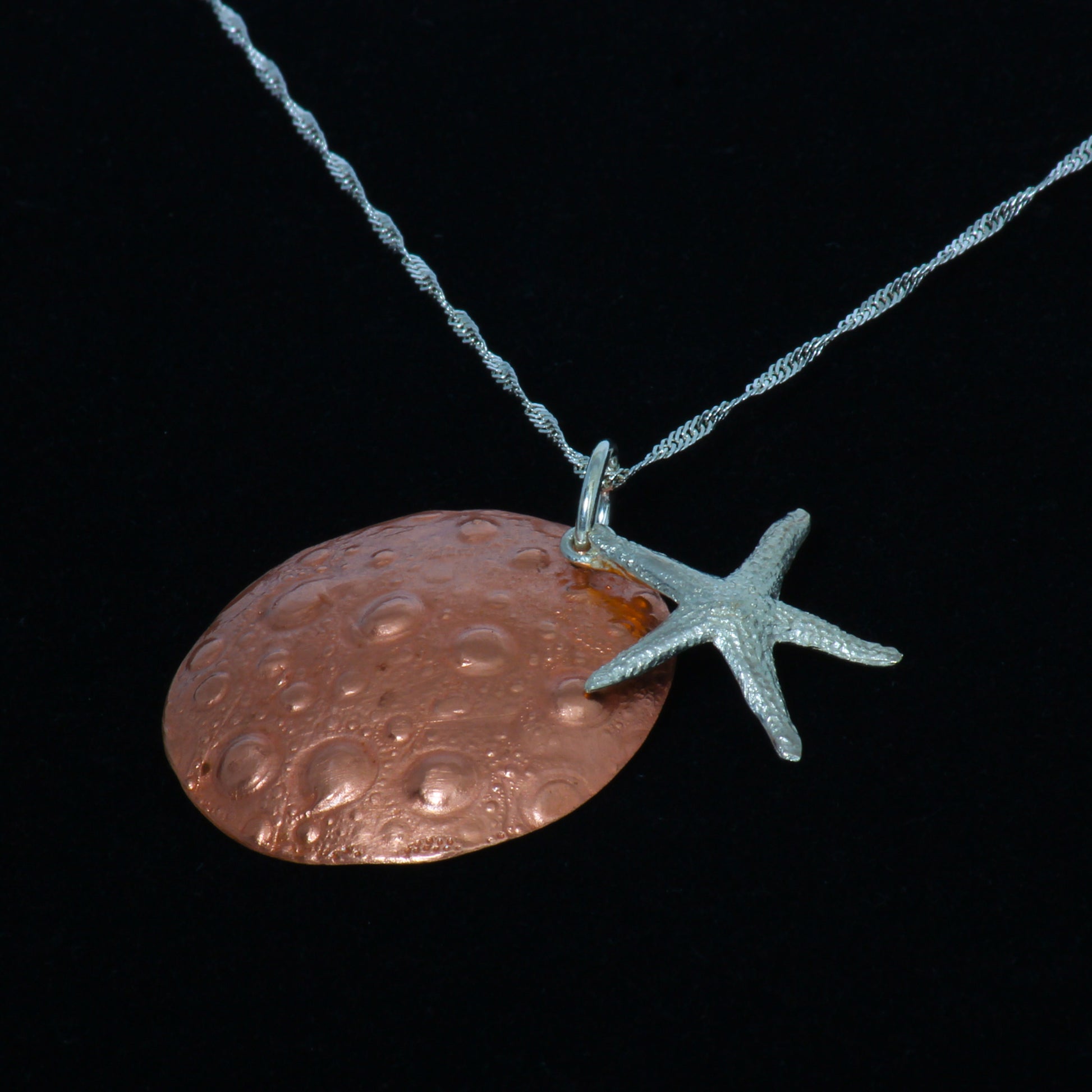 Copper sand dollar and silver starfish necklace