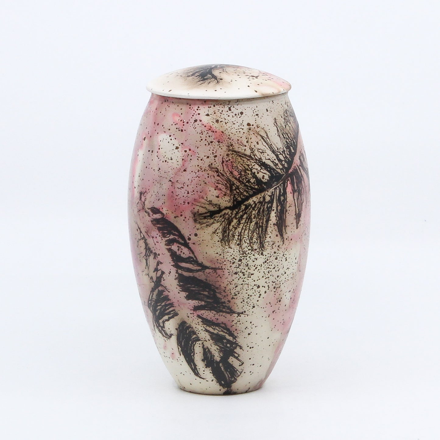 pink lidded vase with burnt feathers