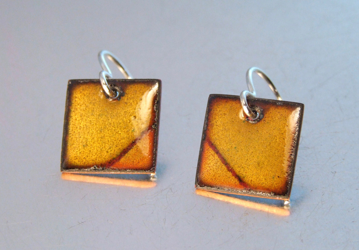 Square caramel coloured earrings: corner