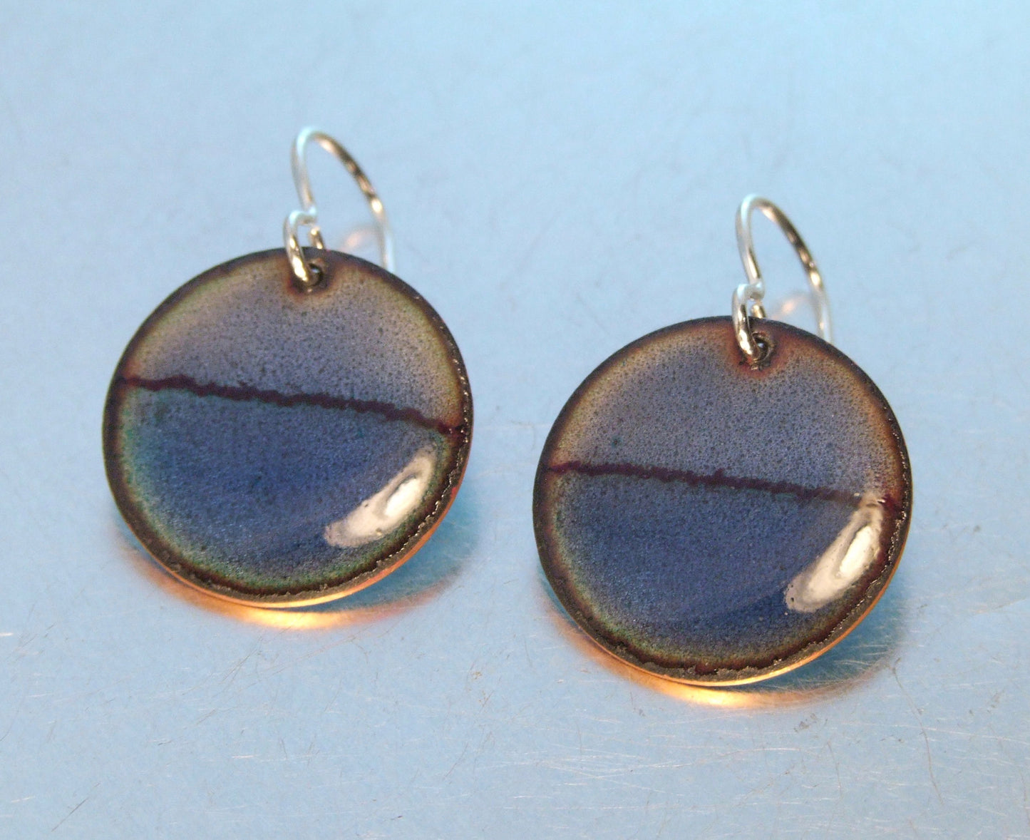 Round half and half blue earrings