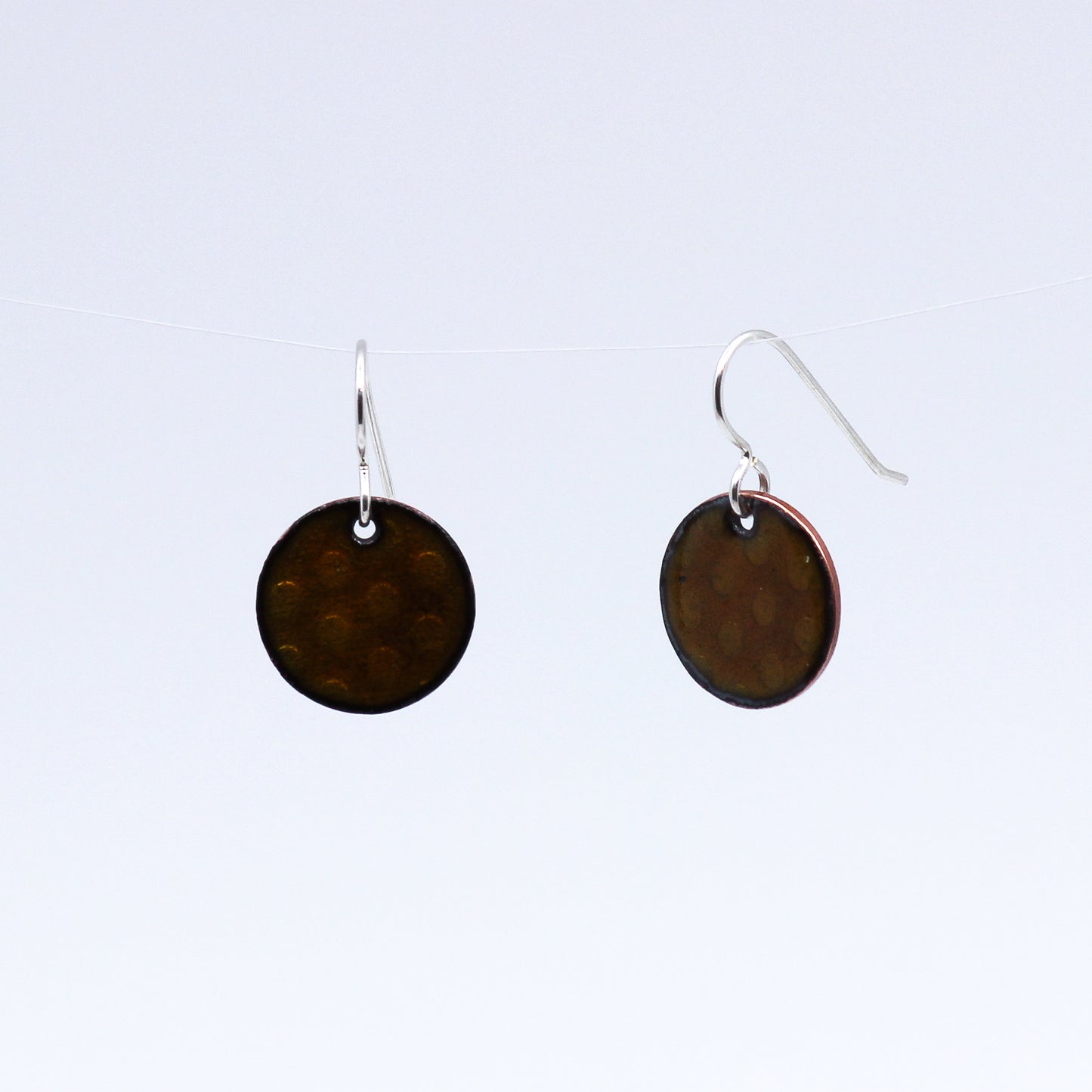Round copper coloured earrings