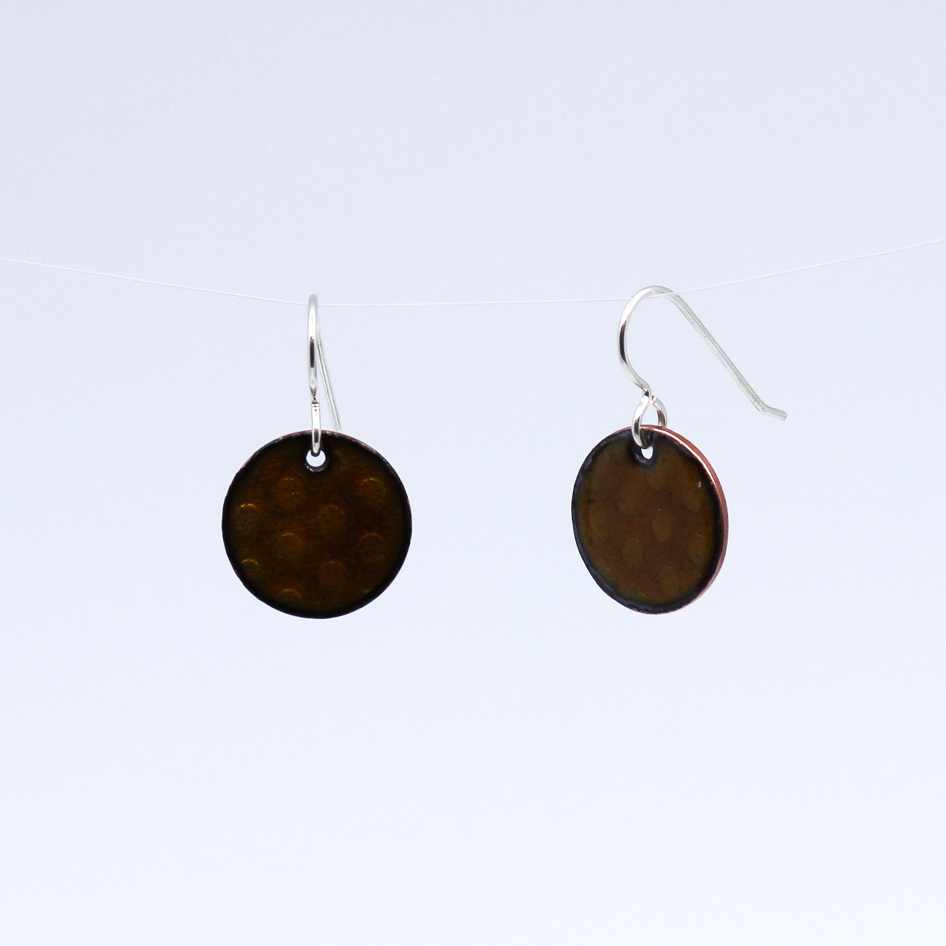 Round copper coloured earrings