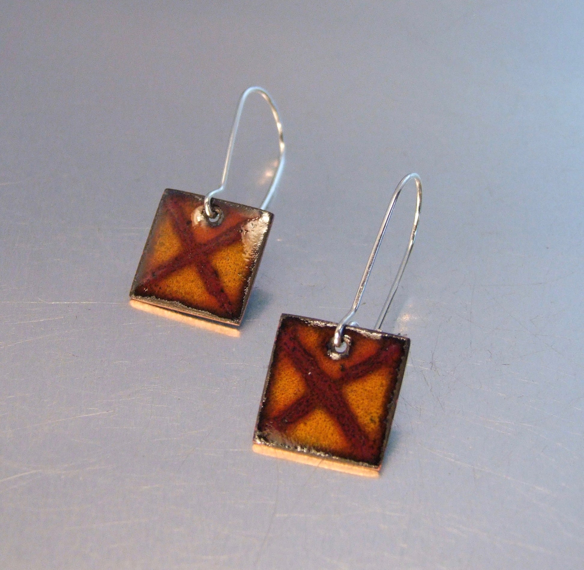 Square caramel coloured earrings:: X