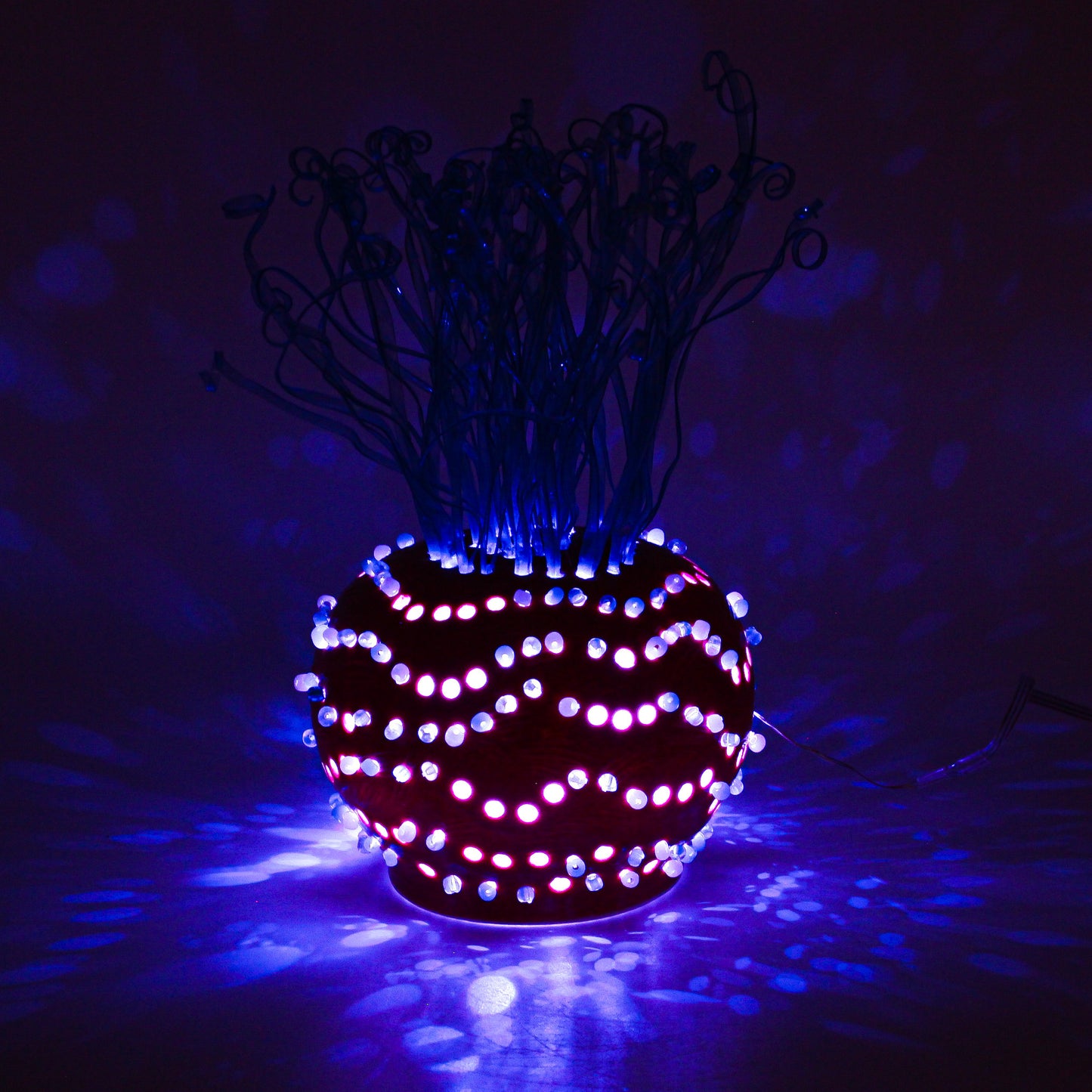 Clay sculpture with beads and recycled plastic , illuminated