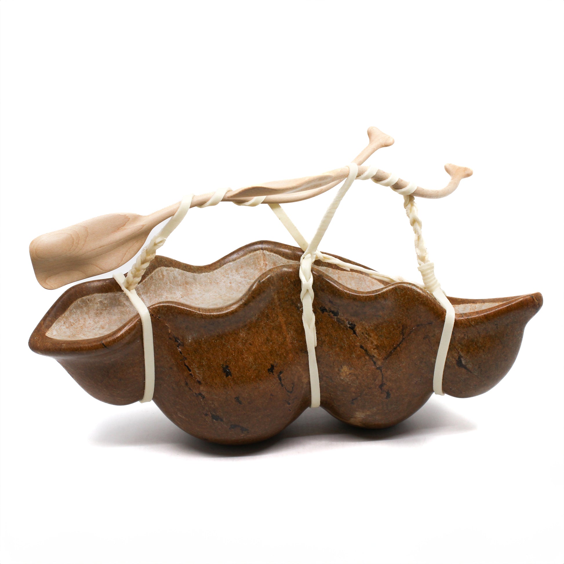 Sculpture of a canoe with paddles