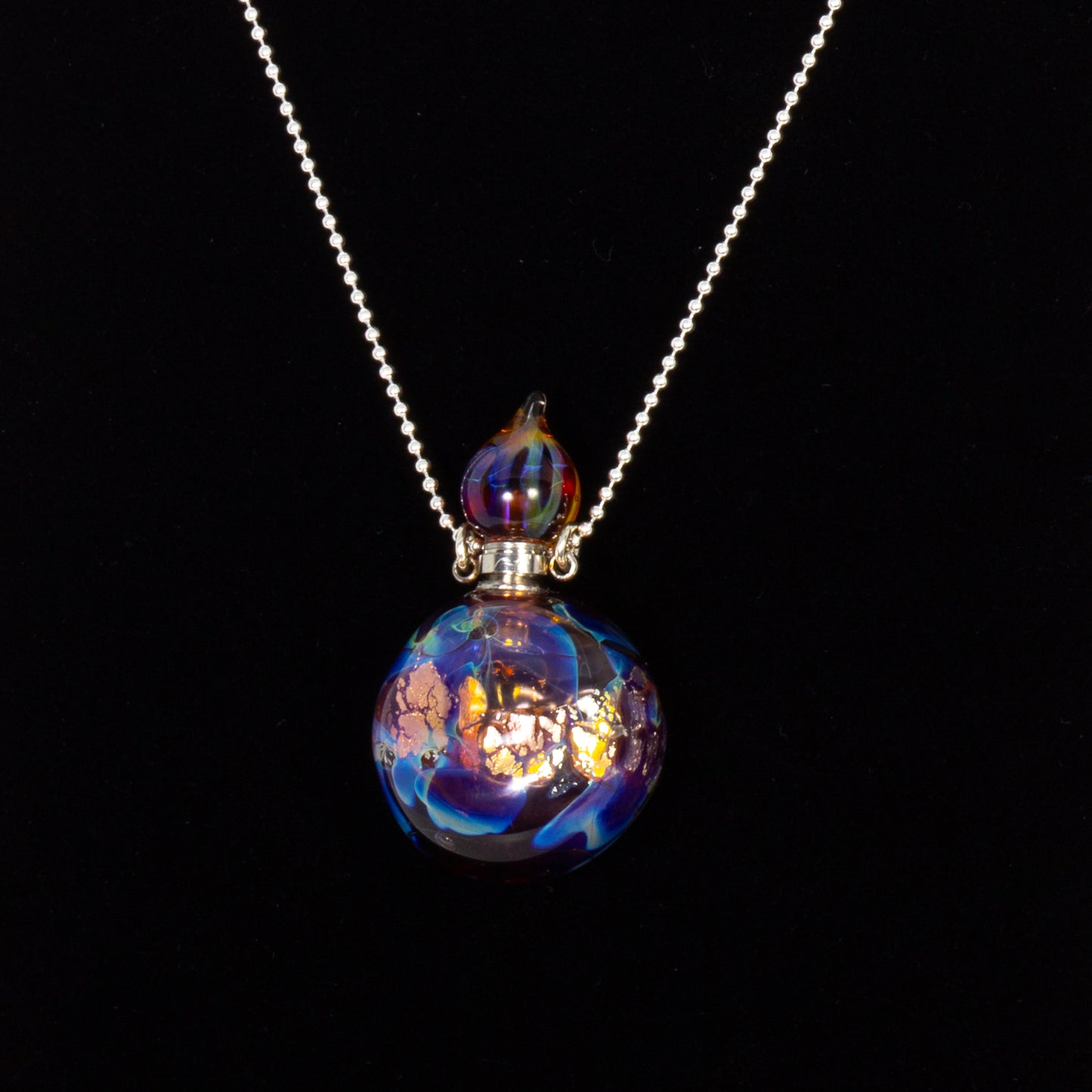 Necklace with a colorful glass pendant on a black background