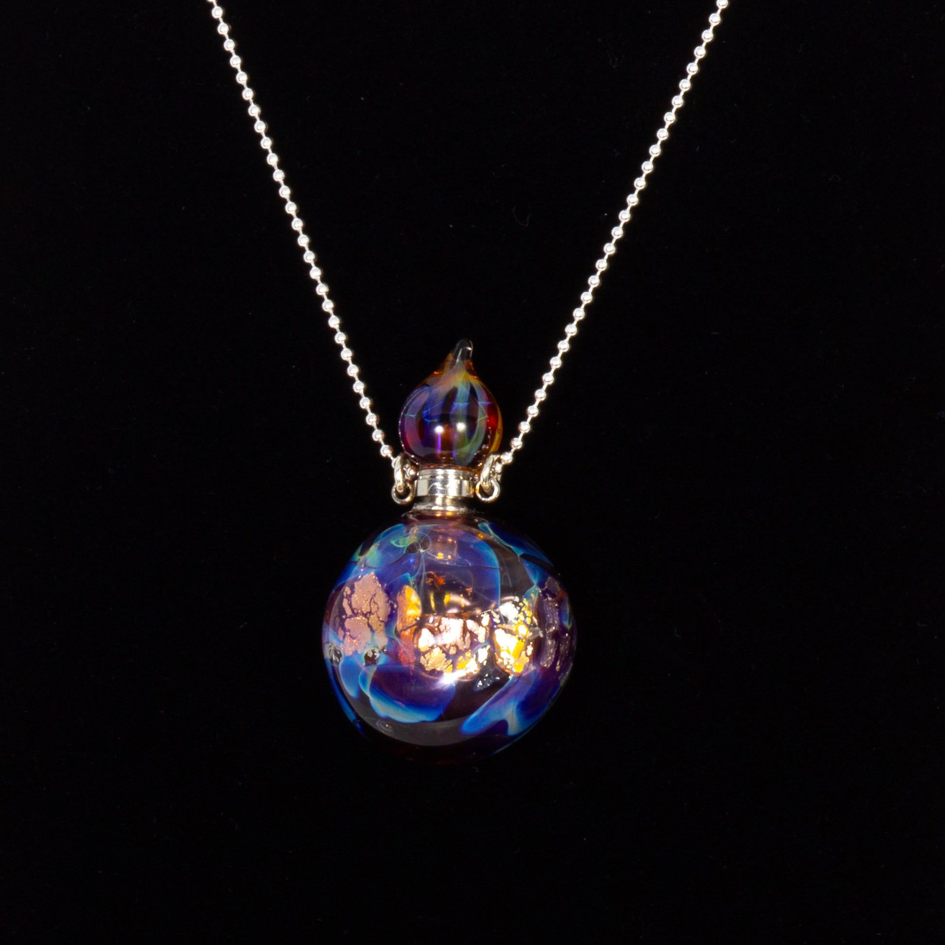 Necklace with a colorful glass pendant on a black background
