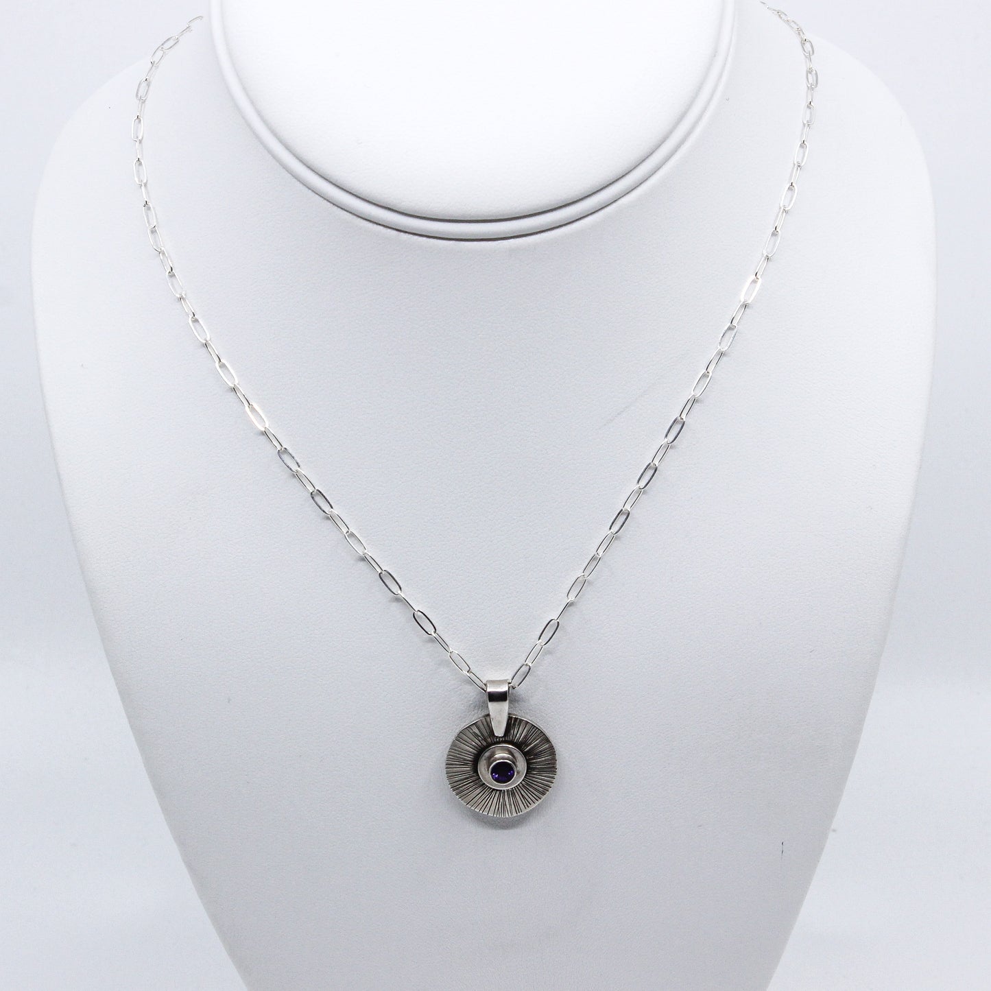 Silver necklace with silver pendant inset with garnet