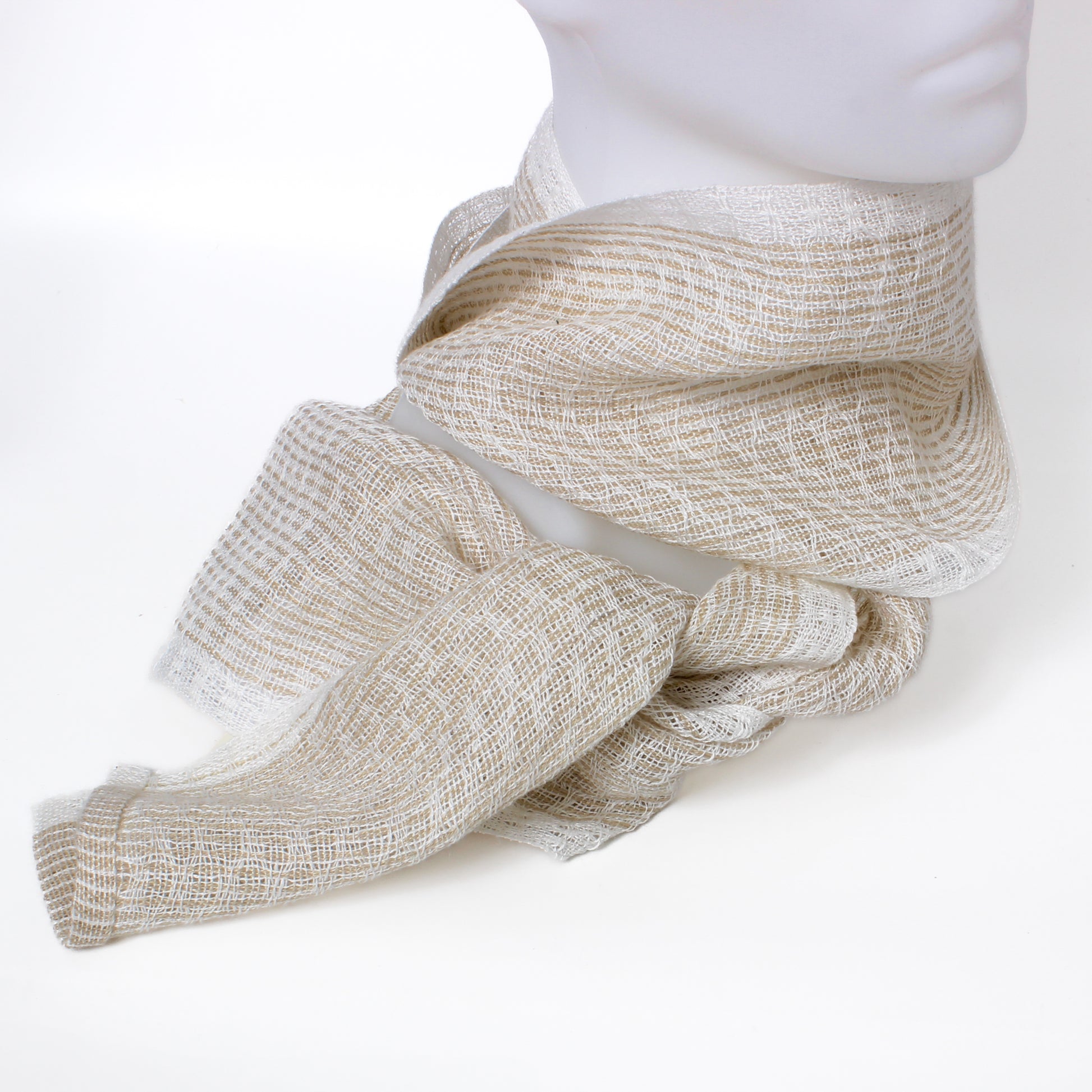 Mannequin wearing a beige textured scarf on a white background
