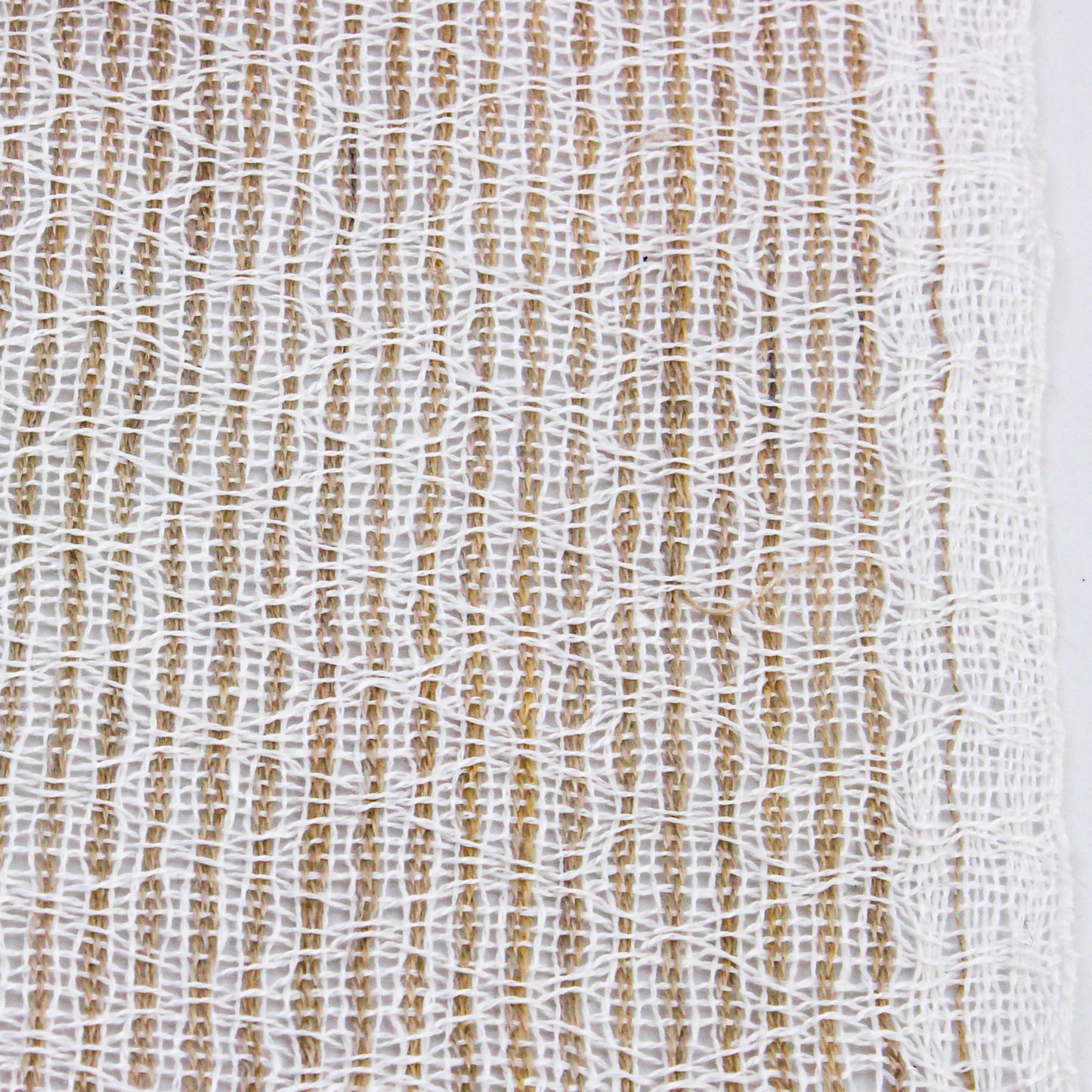 close up detail of white and beige scarf