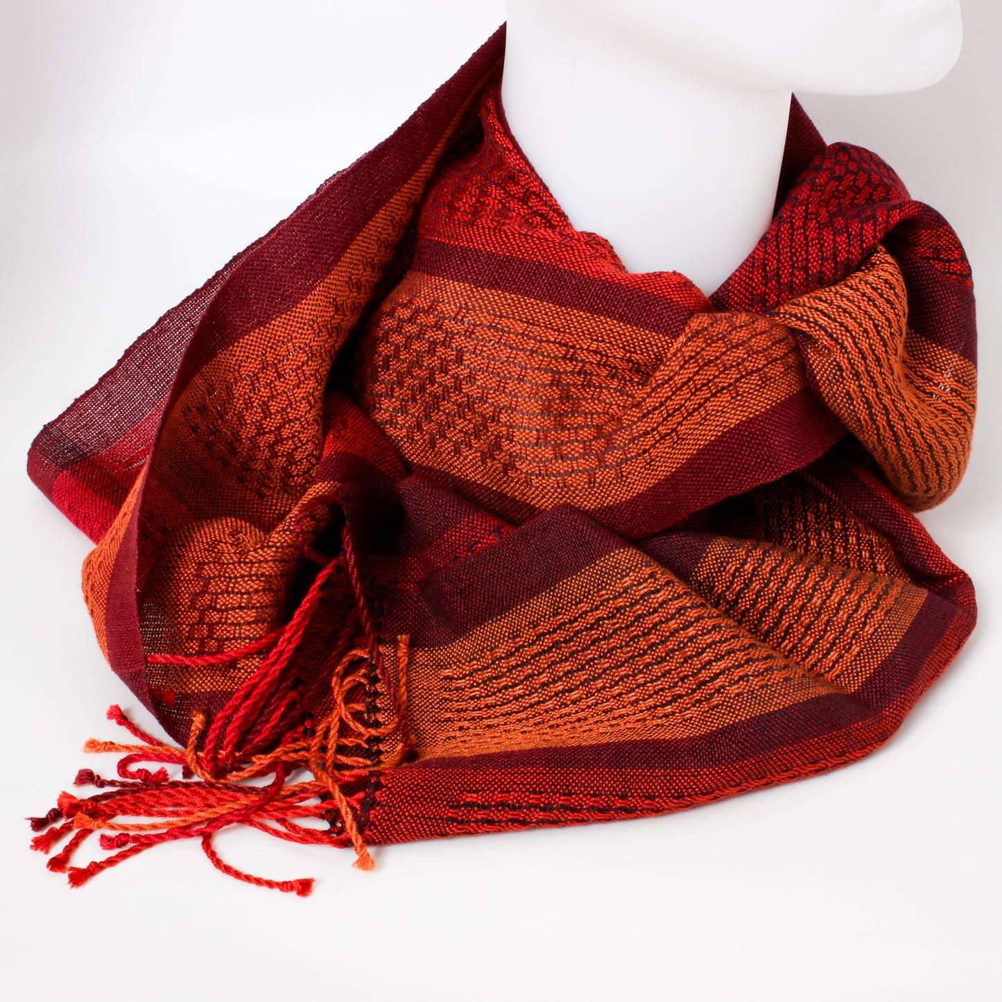 Red and orange striped scarf on a mannequin