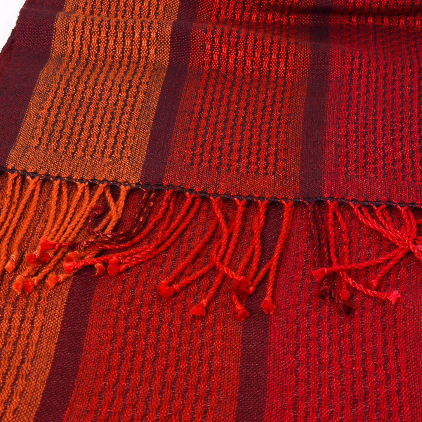 Close-up of a red and orange striped scarf with fringes