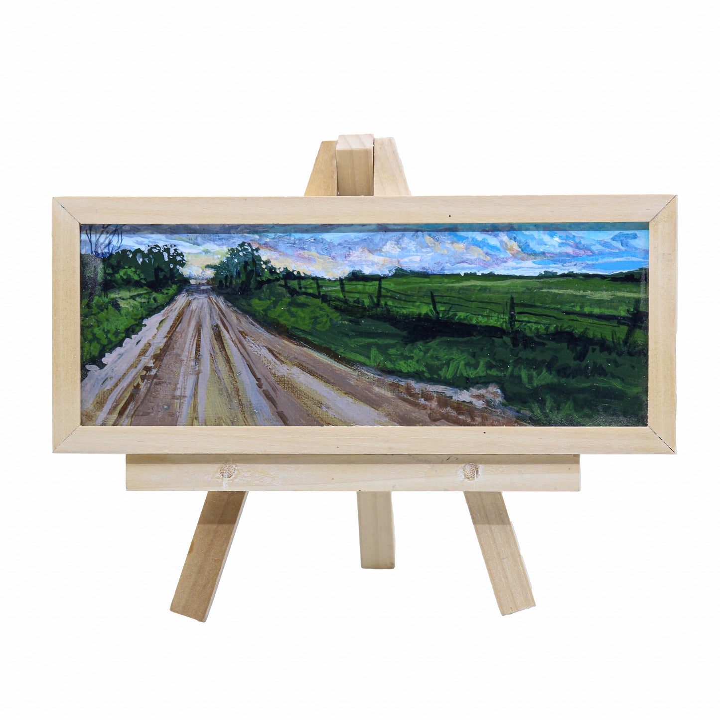 Acrylic painting on easel of prairie road