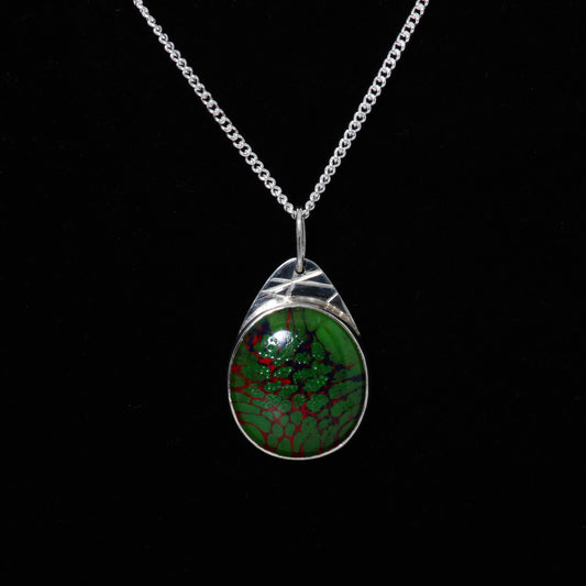 Green and red pendant on silver chain