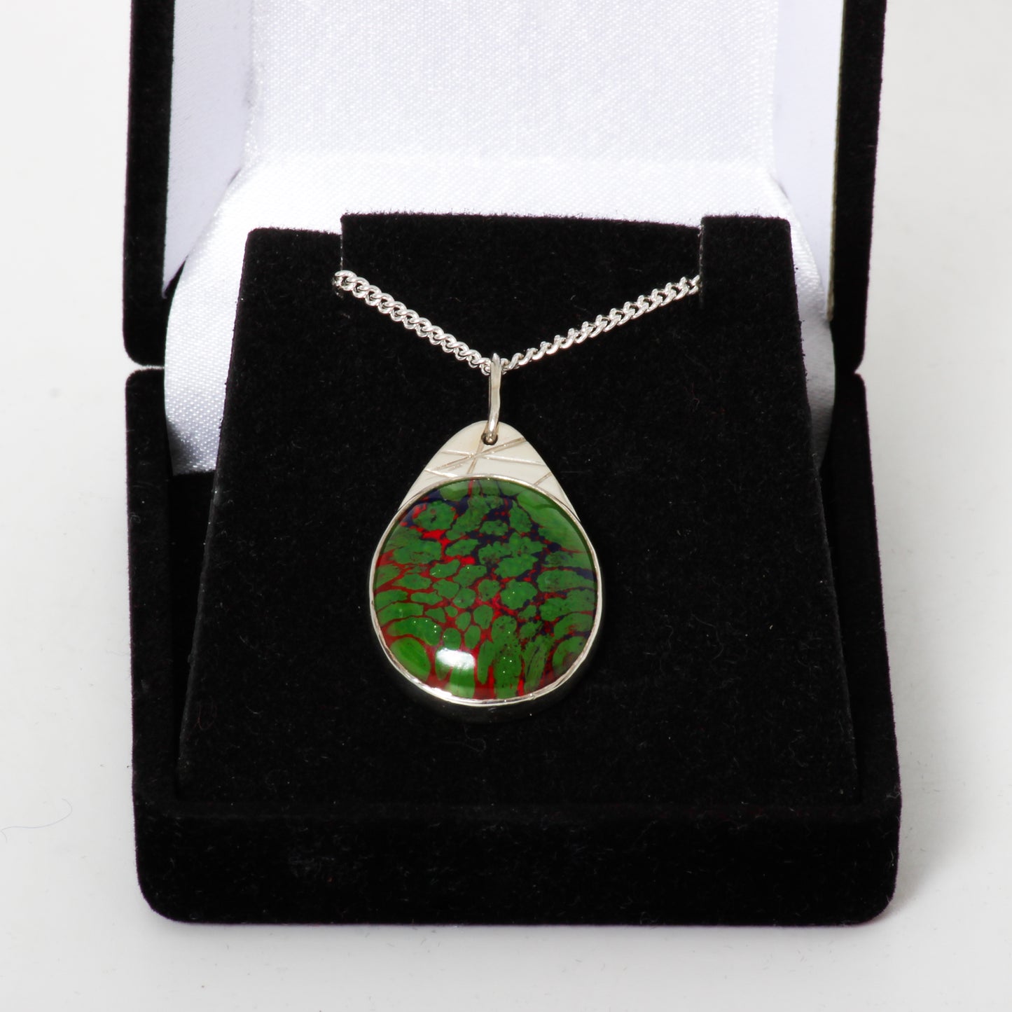 Green and red pendant on silver chain