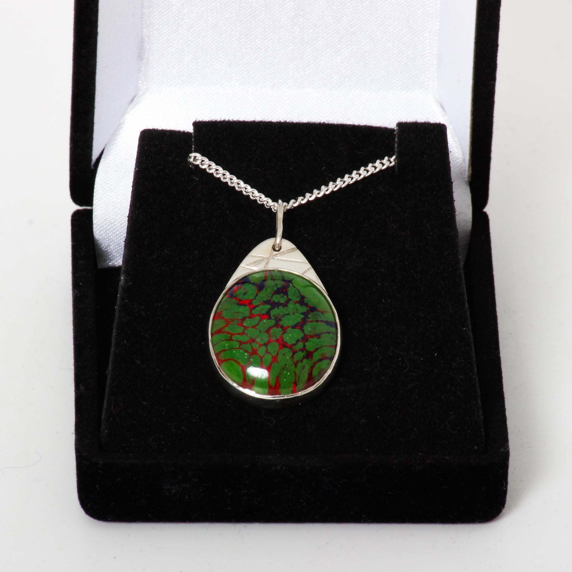 Green and red pendant on silver chain