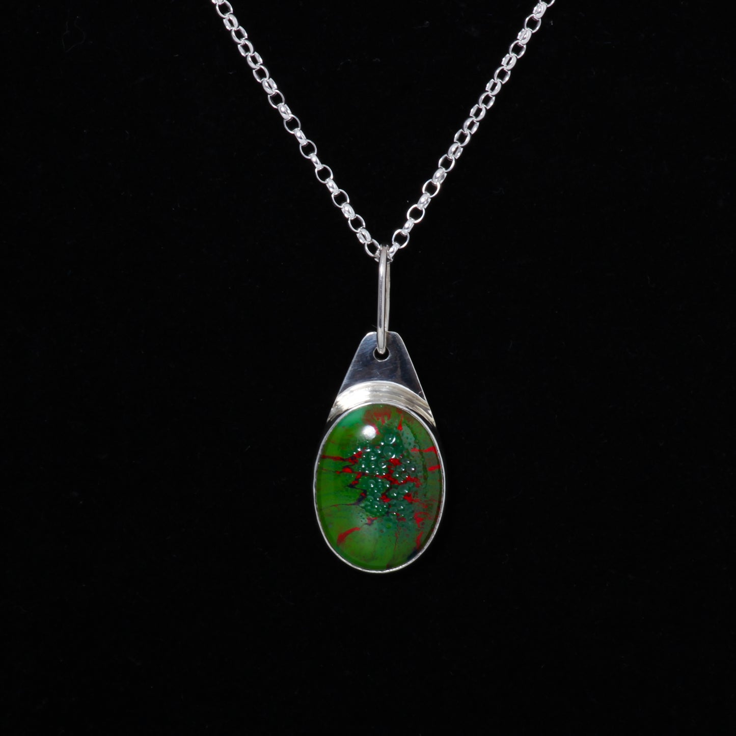 Green and red pendant on silver chain