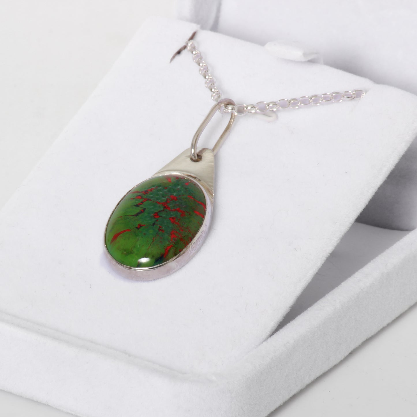 Green and red pendant on silver chain