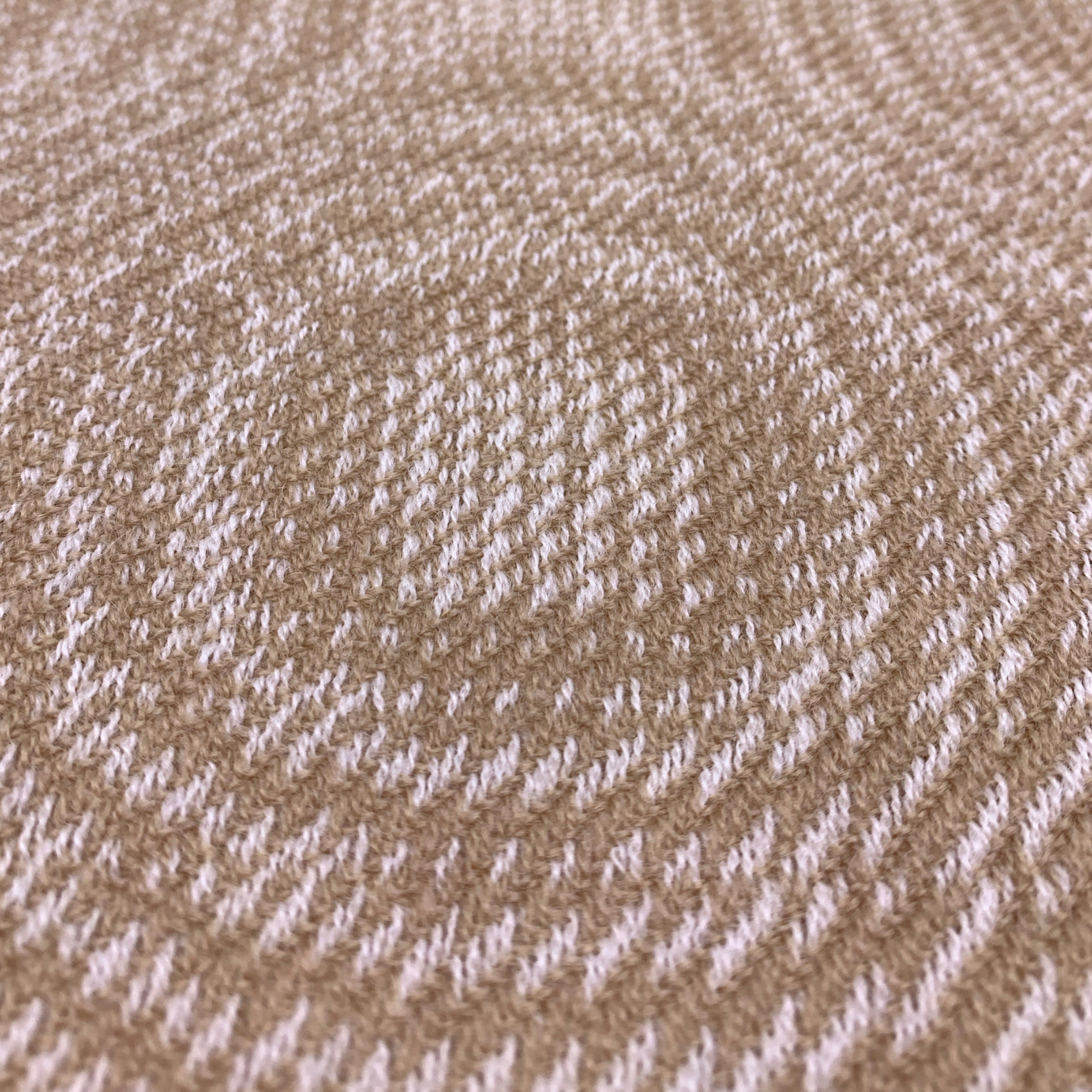 tan and white hand-woven scarf